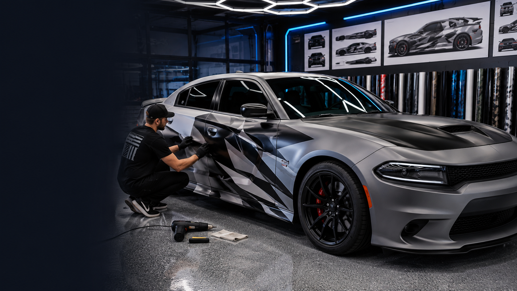 Professional custom car wrap installation on a Dodge Charger with abstract graphic design at Weem Custom shop