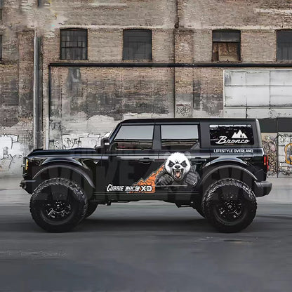 Angry panda cartoon decal applied on dark SUV – outdoor side profile view