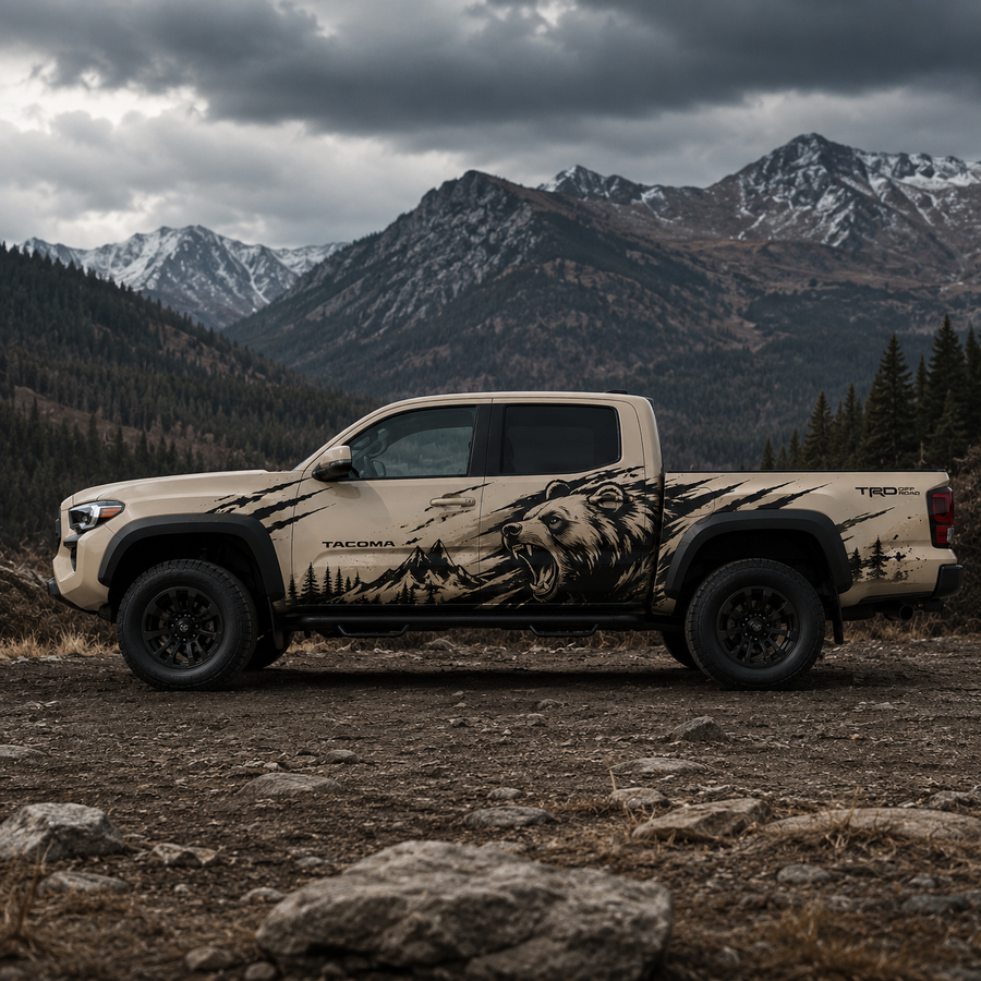 Mountain bear graphic vinyl decal on Toyota Tacoma in dramatic mountain setting