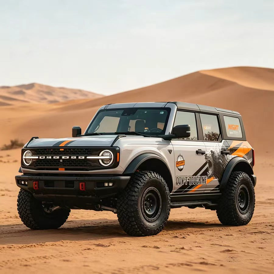 White Ford Bronco with Roaring Bear Warning Aggressive Off-Road Vinyl Wrap in Desert