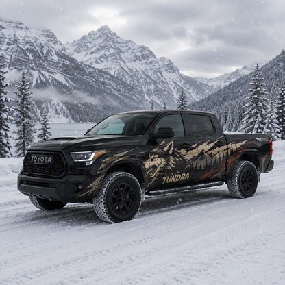 Wild Wolf truck decal on black Toyota Tundra in snowy mountain forest