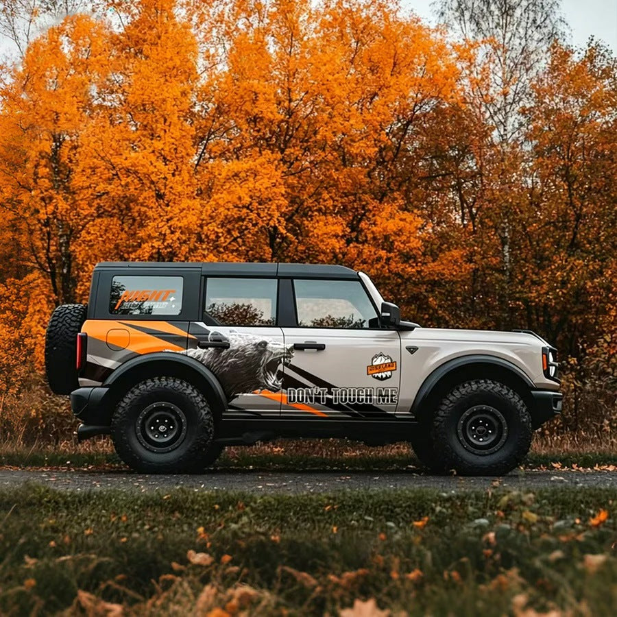 Roaring Bear Warning Car Decal for Ford Bronco – Aggressive Off-Road Vinyl Wrap on White Bronco in Autumn Forest