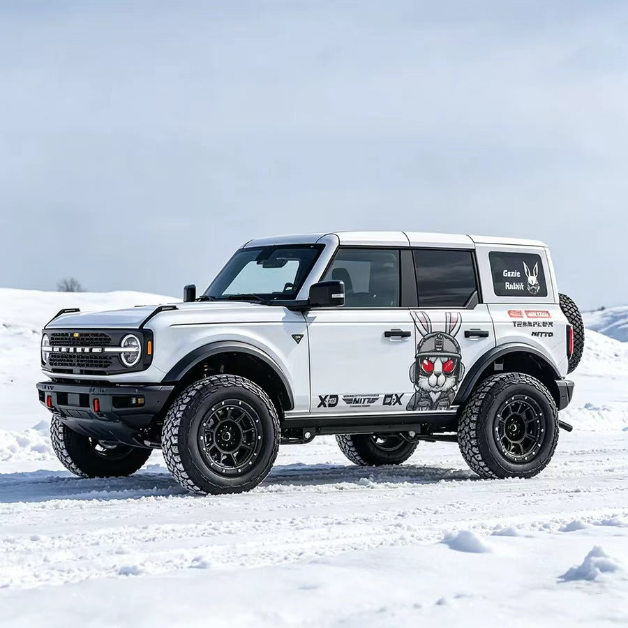 White Ford Bronco with Tactical Rabbit Combat Bunny Off-Road Vinyl Wrap in Snow