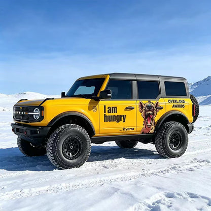 Yellow Ford Bronco with Hyena Aggressive Animal Side Graphic Vinyl Wrap in Snow