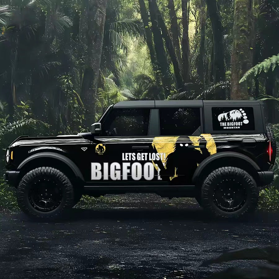 Black Ford Bronco with Bigfoot Myth Creature Vinyl Wrap in Forest – Side Graphic Decal