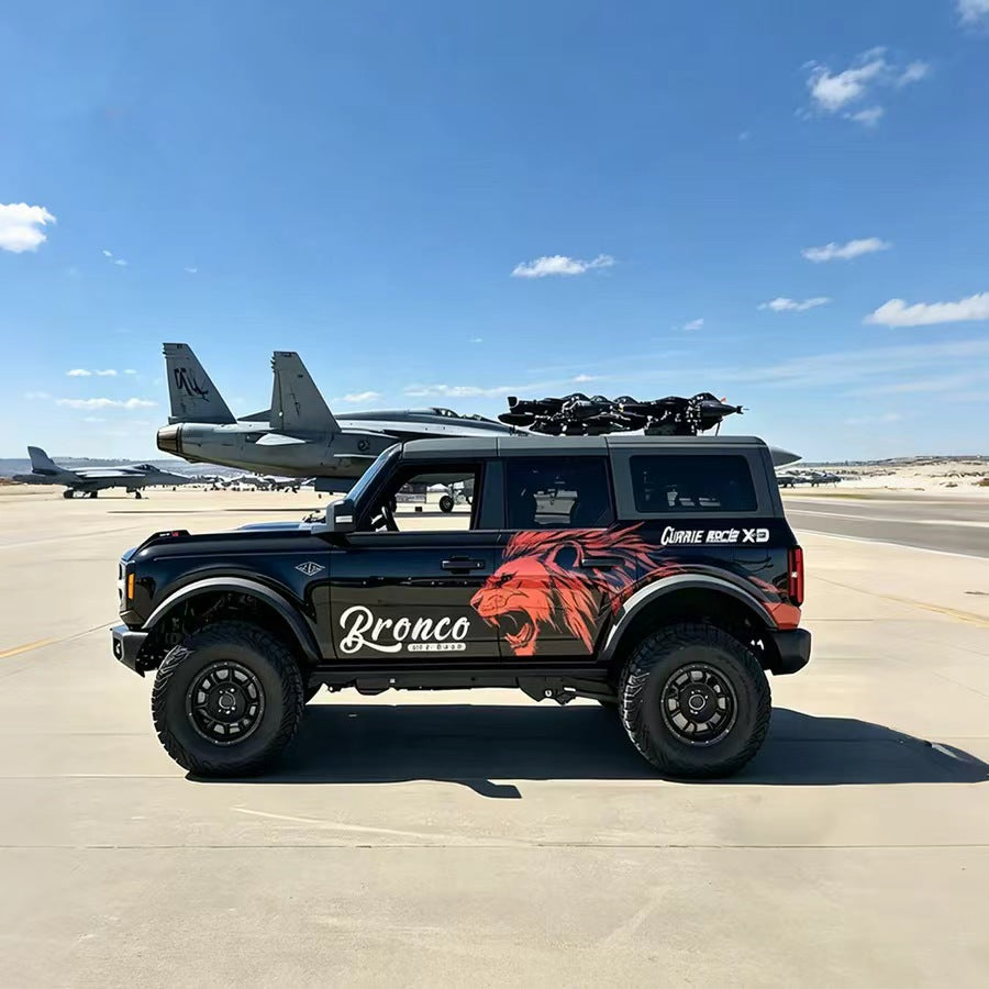 Red Lion Off-Road SUV Decal – Aggressive Animal Side Vinyl Wrap on Black Ford Bronco at Military Airport