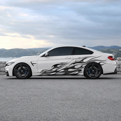 White BMW M4 with black flame side graphic decal parked by coastal road – full side profile