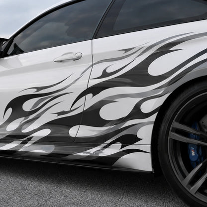 Close-up of black and gray tribal flame vinyl decal applied on white car door panel