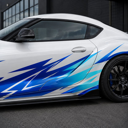 Close-up of blue and teal lightning spike vinyl decal on white Toyota Supra GR door panel – detailed jagged bolt pattern view