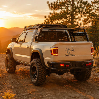 Cat'teryx parody cat vinyl decal sticker on Toyota Tacoma tailgate at sunset