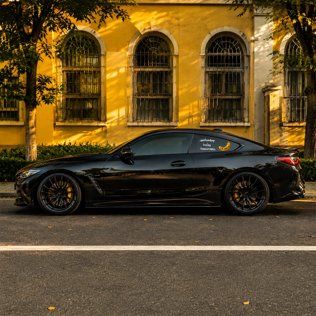 Black BMW with CN Wagon banana rear window decal parked on street – custom vinyl car sticker