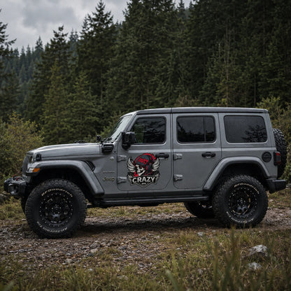 Crazy 4x4 300PCT skull vinyl decal on gray Jeep Wrangler Sahara full side view forest trail