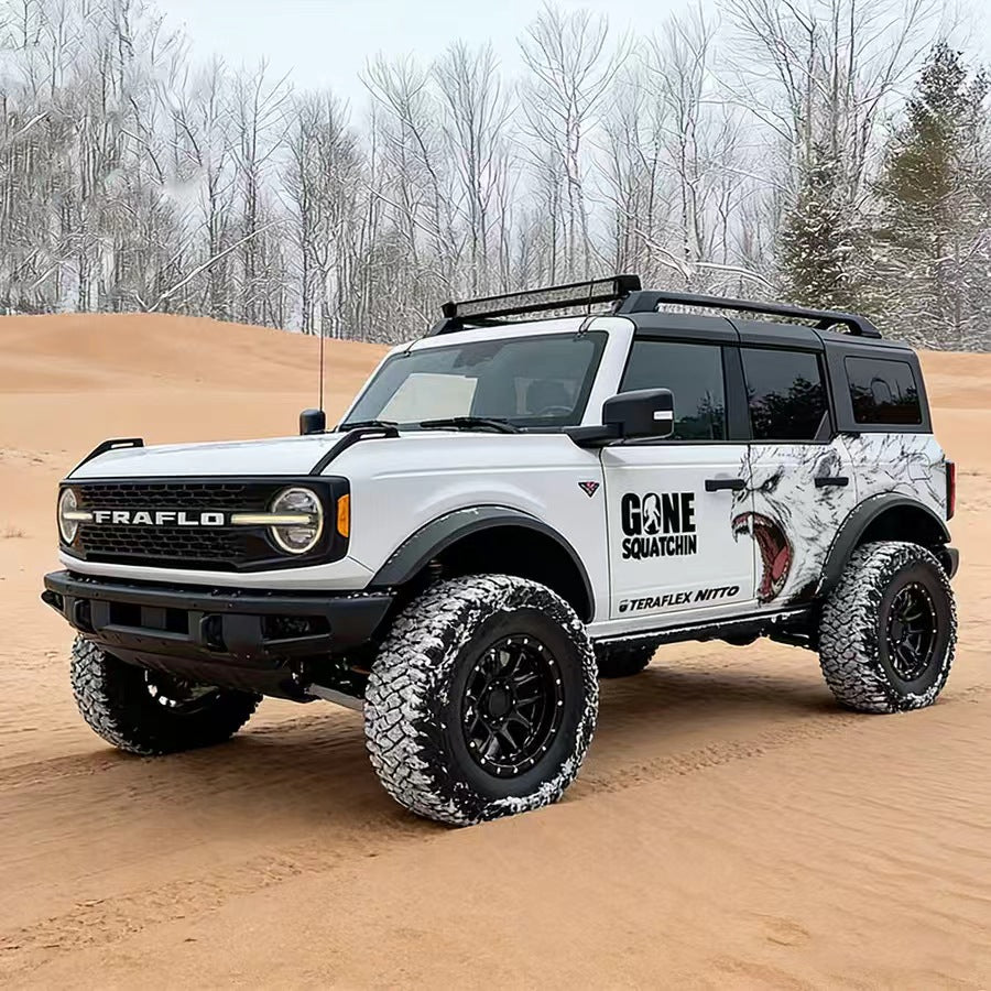 White Ford Bronco with Arctic Wolf Roaring Predator Off-Road Side Graphic Vinyl Wrap in Desert