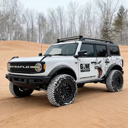 White Ford Bronco with Arctic Wolf Roaring Predator Off-Road Side Graphic Vinyl Wrap in Desert