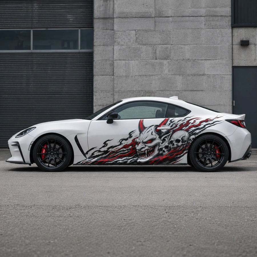 White Toyota GR86 with demon skull side decal – full side profile in urban concrete garage setting