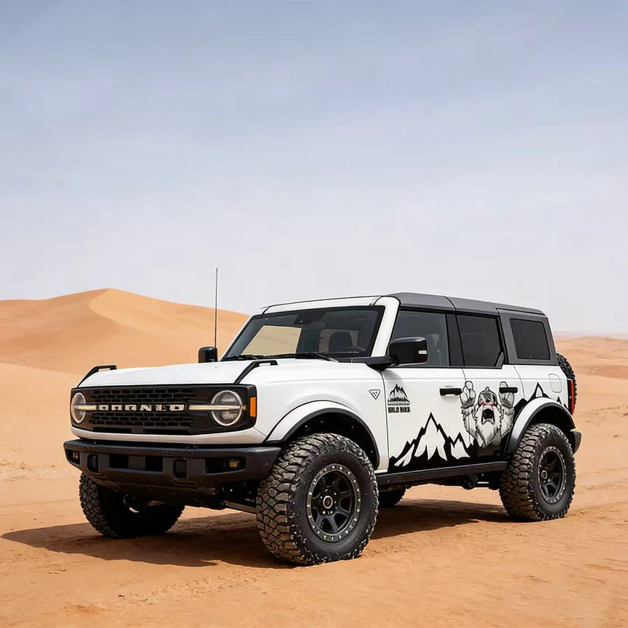 White Ford Bronco with Sasquatch Mountain Bigfoot Wilderness Off-Road Side Wrap in Desert