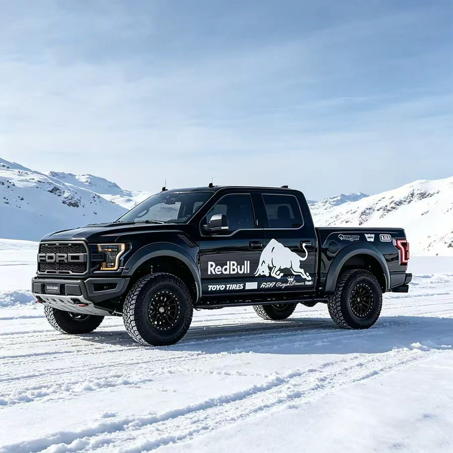 Charging bull truck decal on black Raptor pickup – full side view in snowy outdoor setting