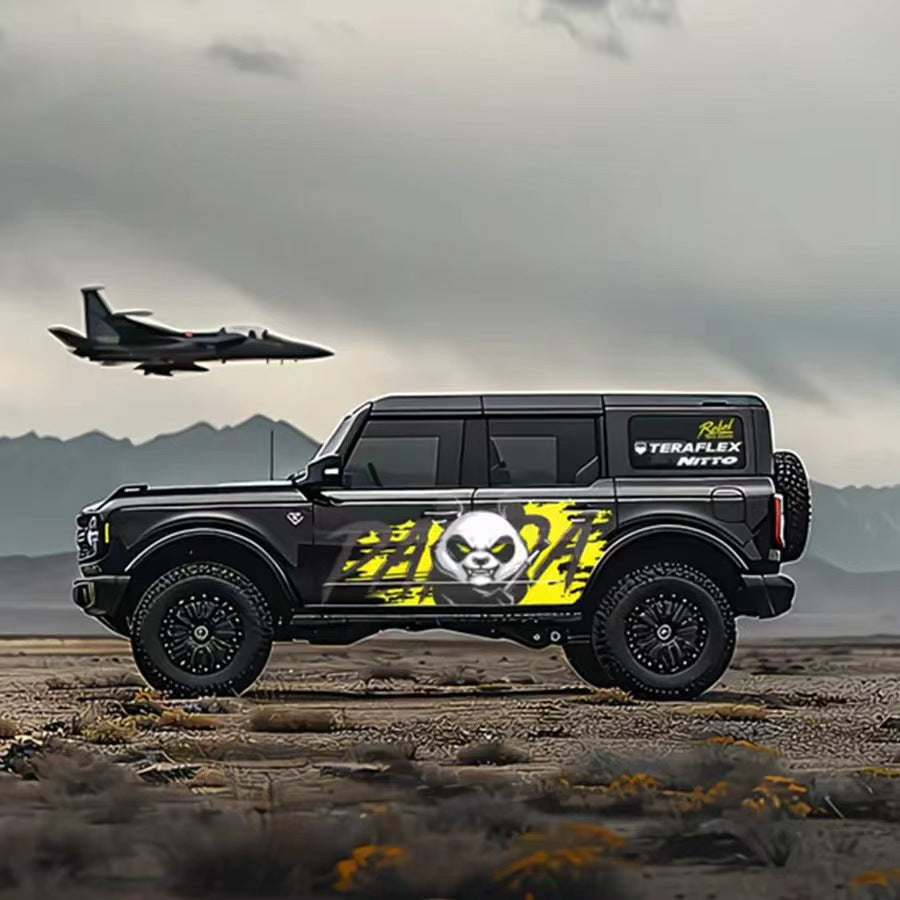 Aggressive panda graffiti vinyl wrap on black Jeep Wrangler SUV – neon yellow skull panda side graphic, coastal airfield background