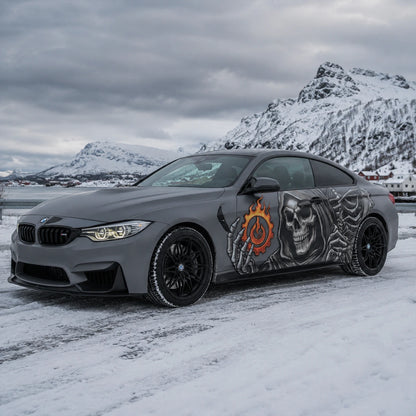 Grim reaper skull vinyl car side decal on matte gray BMW M4 – front 3/4 view in snowy Norwegian fjord setting