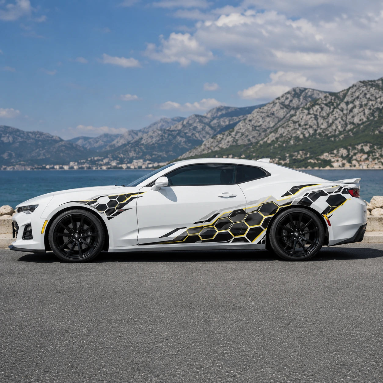 White Chevrolet Camaro ZL1 with black and gold honeycomb car side decal – full side profile by Mediterranean coastal road