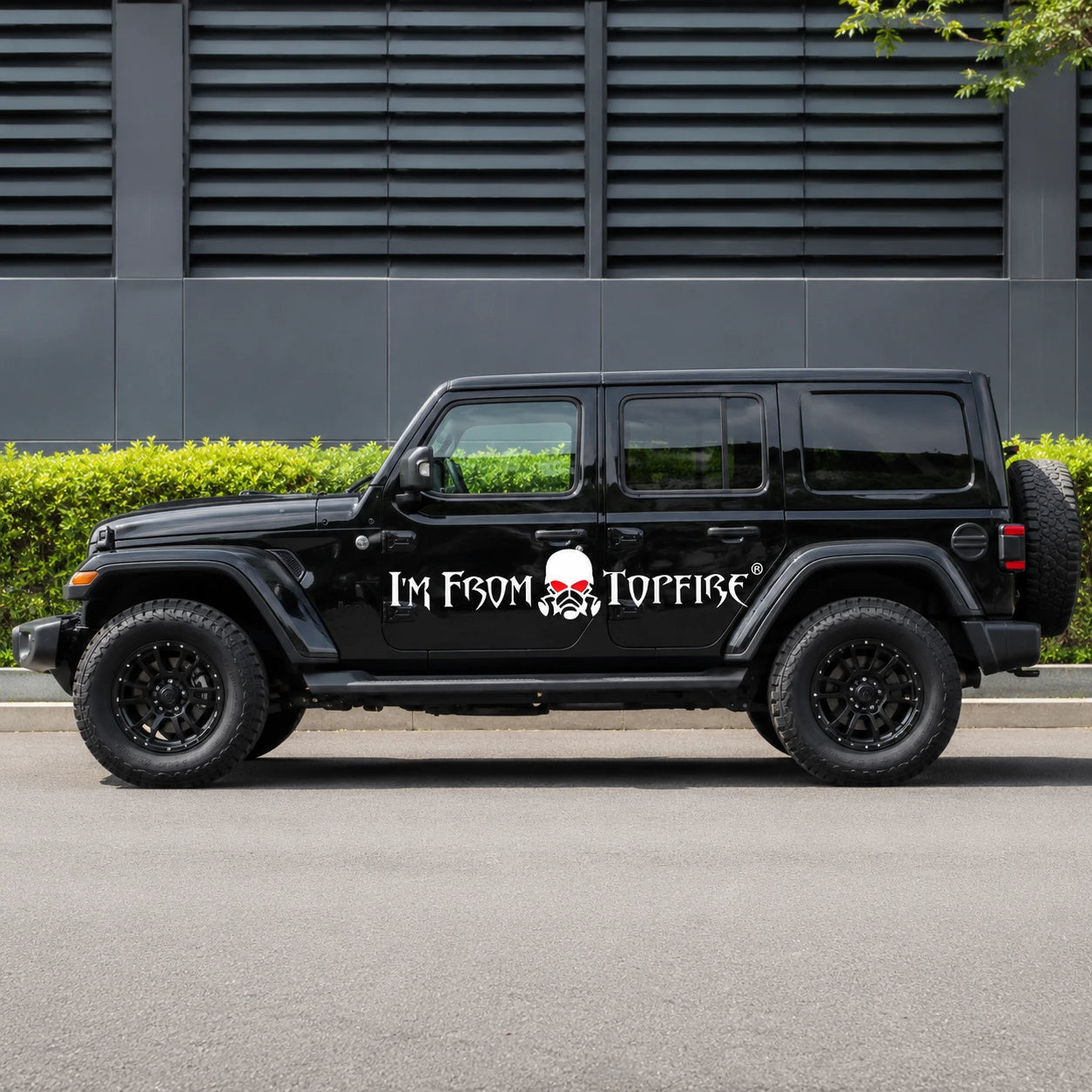 I'm From Topfire vinyl banner decal full side view on black Jeep Wrangler Unlimited parked on street