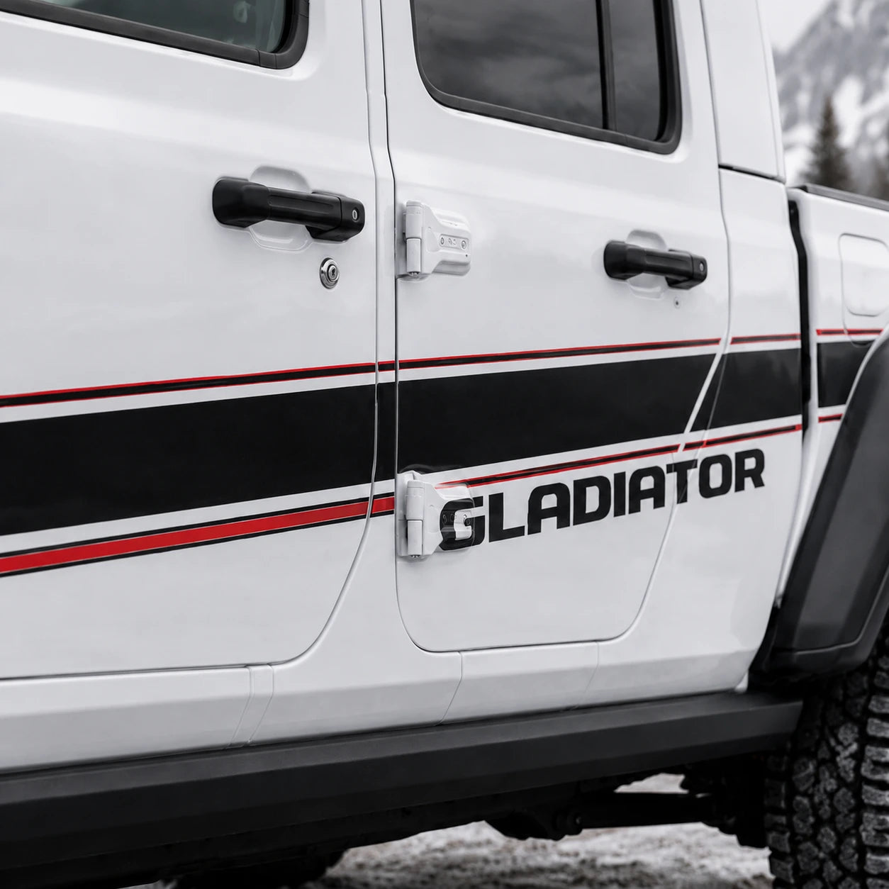 Jeep Gladiator Rubicon sport stripe decal – close-up door panel black red GLADIATOR stripe detail in snow