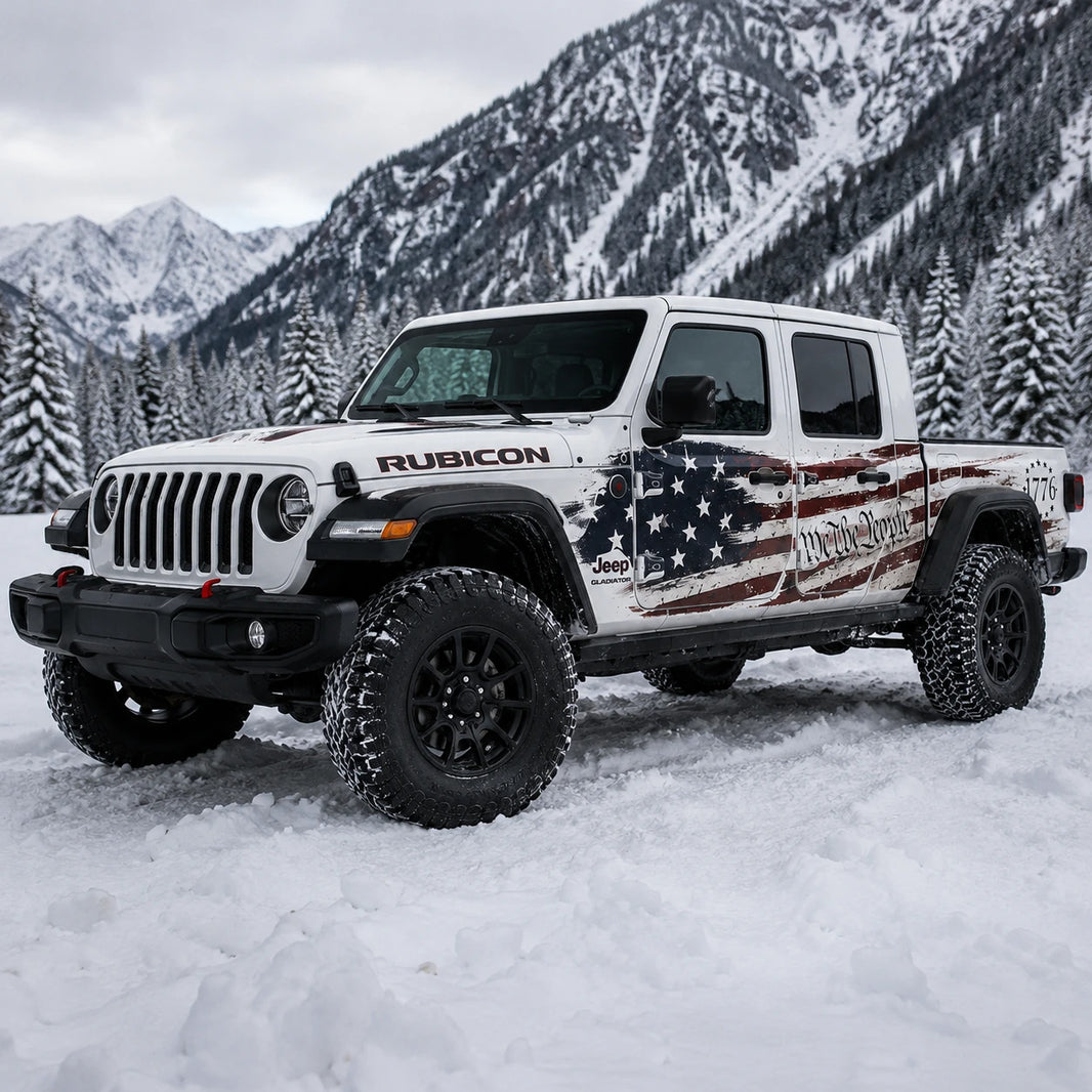Jeep Gladiator Rubicon We The People 1776 American flag decal – front 3/4 view in snowy alpine pine forest mountain setting