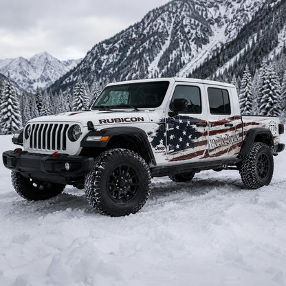 Jeep Gladiator Rubicon We The People 1776 American flag decal – front 3/4 view in snowy alpine pine forest mountain setting