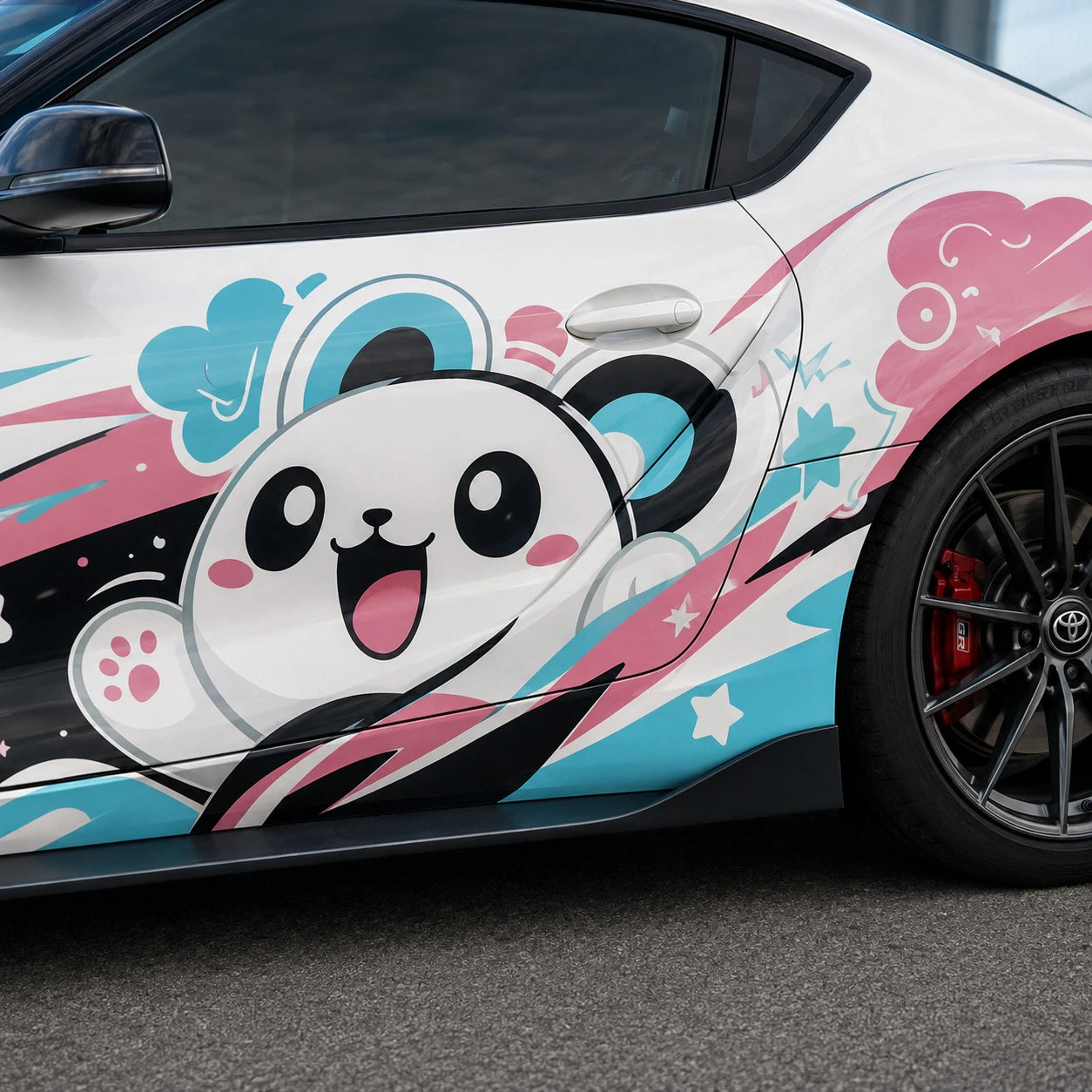 Close-up of kawaii panda cartoon with pink clouds and teal lightning vinyl decal on white Toyota Supra door panel – detailed anime artwork view