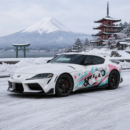 White Toyota Supra GR with kawaii panda anime side decal – front 3/4 view by snowy Mount Fuji with Japanese pagoda and torii gate