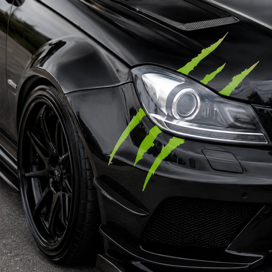 Green monster claw scratch vinyl decal close-up on black Mercedes-Benz C-Class AMG hood and fender showing three razor-sharp claw marks