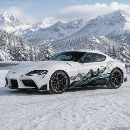 White Toyota Supra GR with mountain landscape car side decal – front 3/4 view in snowy alpine forest with mountain peaks