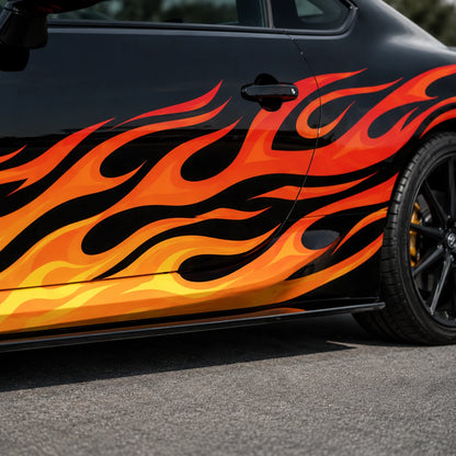 Close-up of red orange and yellow gradient flame vinyl decal on black Toyota GR86 door panel – detailed fire artwork view