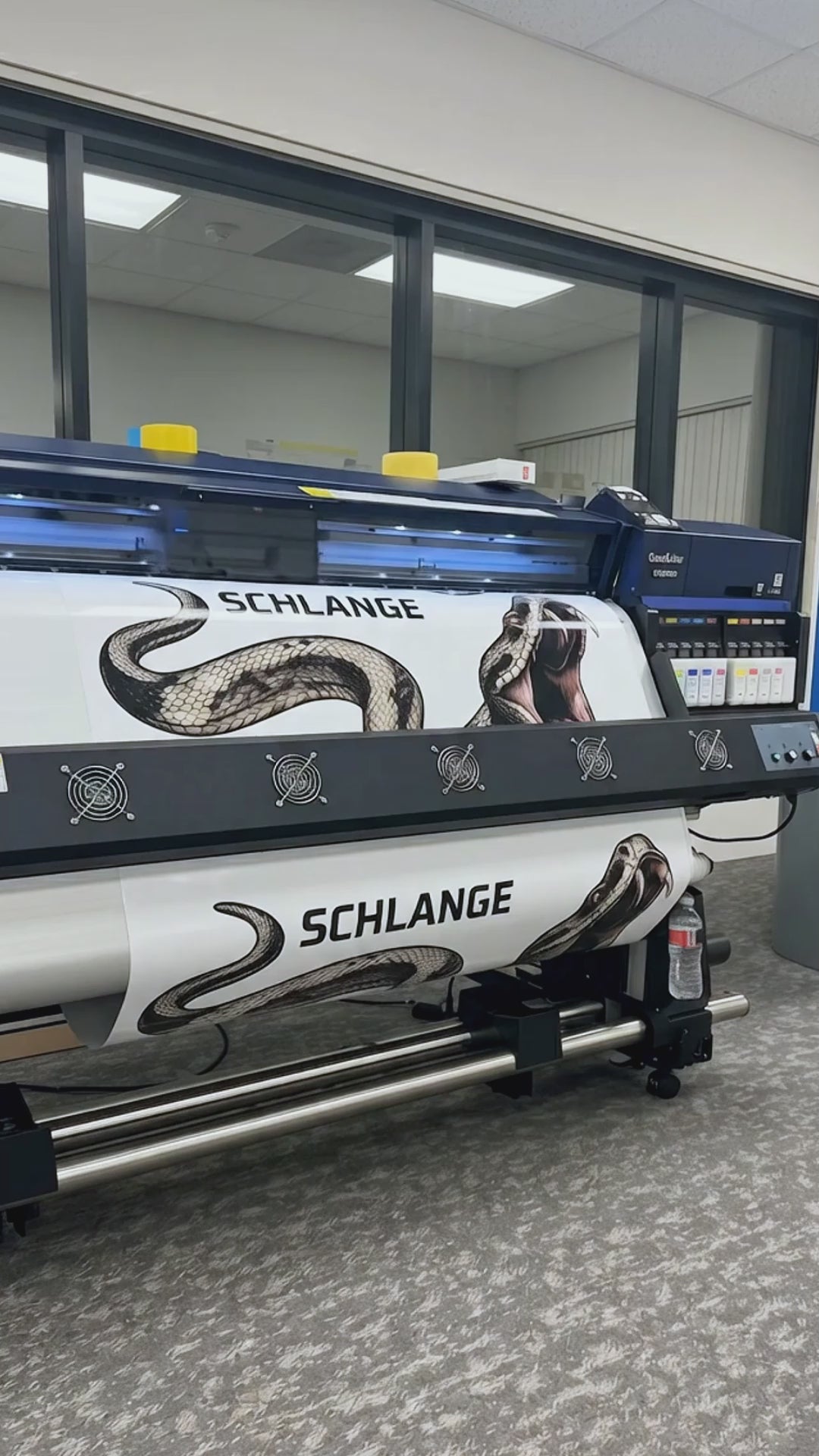 Load Video: Large format printer outputting SCHLANGE custom snake graphic vehicle decal — professional car wrap printing process by WEEM Custom