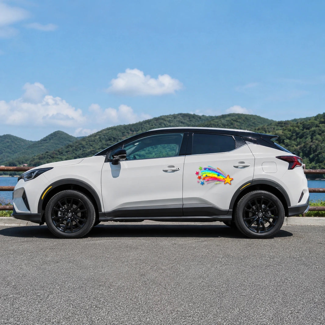 Rainbow shooting star vinyl decal installed on white Toyota SUV full side view by lakeside