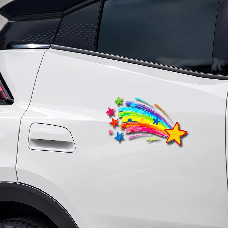 Rainbow shooting star vinyl decal close-up on white SUV rear door panel showing colorful star detail