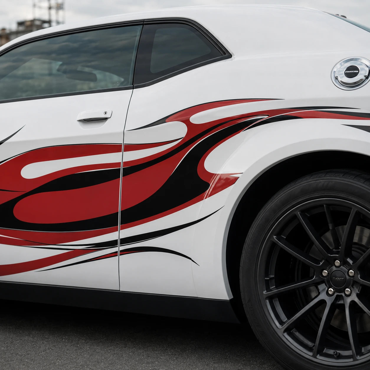 Red black flame decal close up on Dodge Challenger door and rear quarter panel