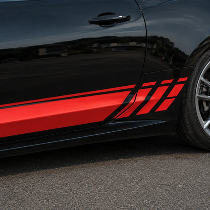 Close-up of red and black racing stripe vinyl decal with slash accents on black car door and rocker panel