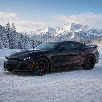 Black Chevrolet Camaro ZL1 with red honeycomb car side decal – front 3/4 view in snowy alpine mountain landscape
