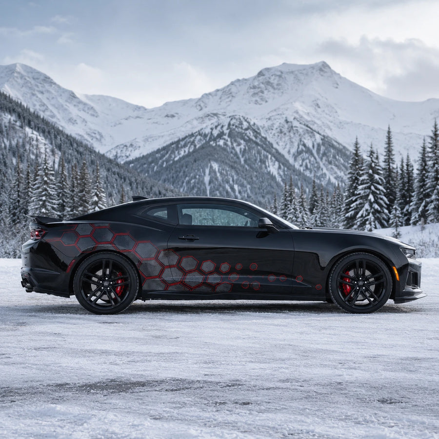 Black Chevrolet Camaro ZL1 with red honeycomb hex side decal – full side profile in snowy alpine mountain setting