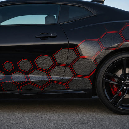 Close-up of black and red honeycomb hexagon vinyl decal on black car door and rear quarter panel – detailed pattern view