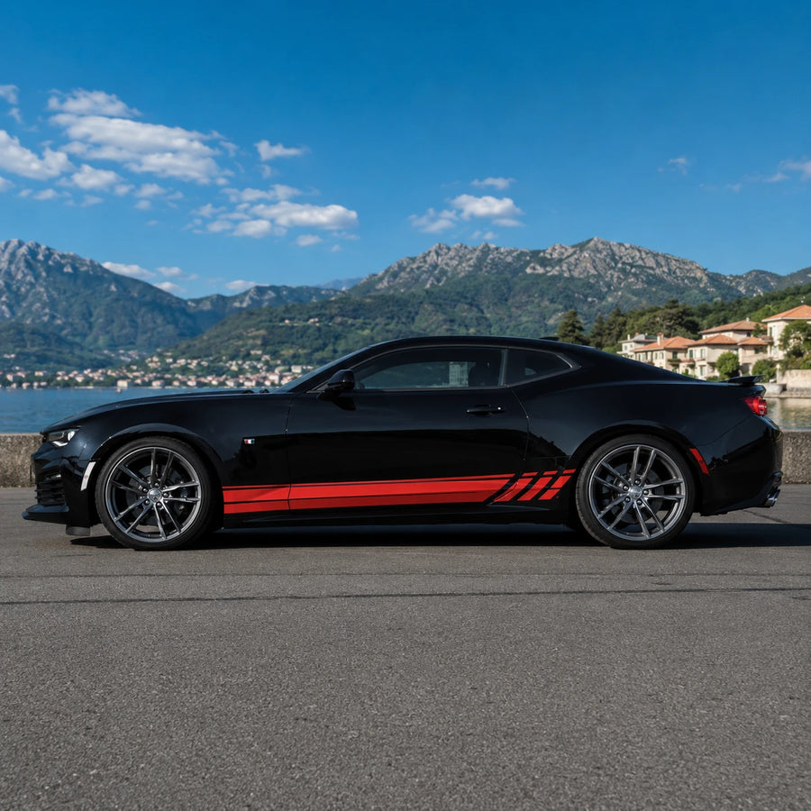 Black Chevrolet Camaro with red racing stripe side decal – full side profile by Italian lake and mountain backdrop