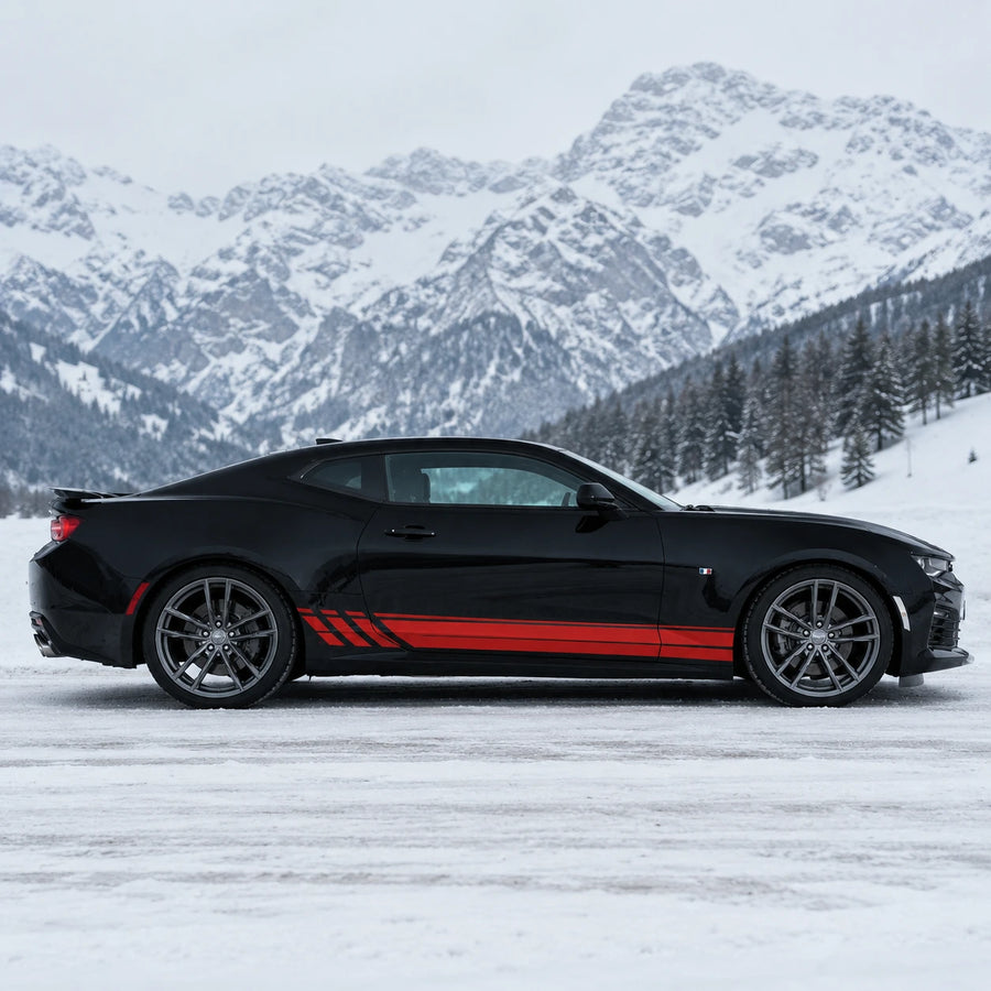 Black Chevrolet Camaro with red racing stripe side decal – full side profile in snowy alpine mountain setting