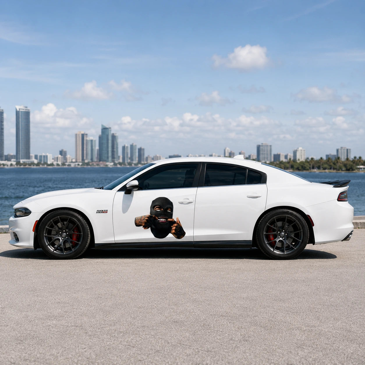 Ski mask tattooed hands vinyl decal installed on white Dodge Charger rear door full side view by waterfront city skyline