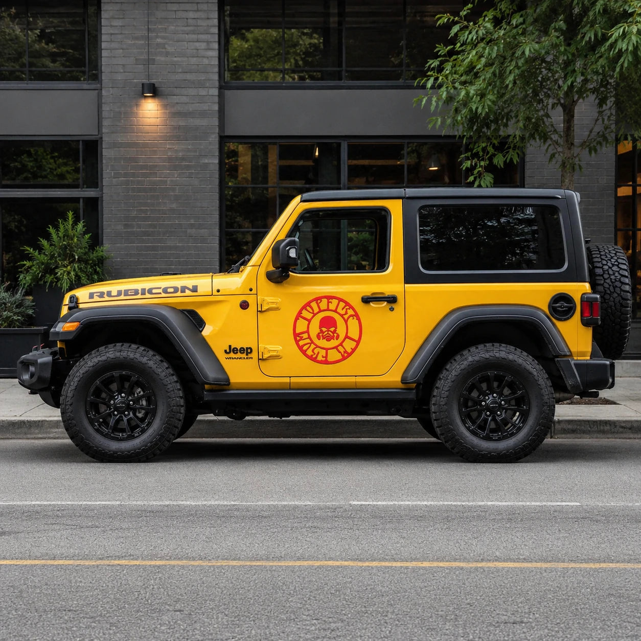 Red skull gas mask circle decal on yellow Jeep Wrangler Rubicon full side view on city street