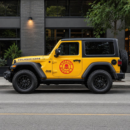 Red skull gas mask circle decal on yellow Jeep Wrangler Rubicon full side view on city street