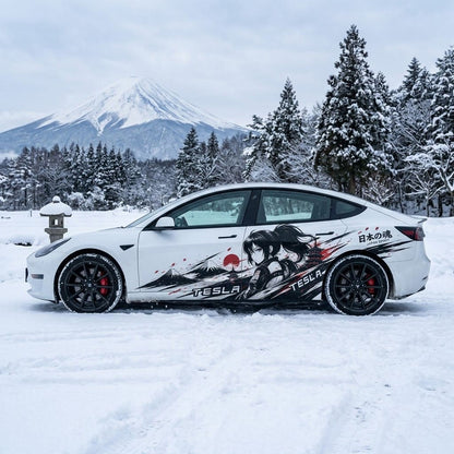 Tesla Model 3 with Japan Spirit samurai anime side decal parked in front of snow-covered Mount Fuji