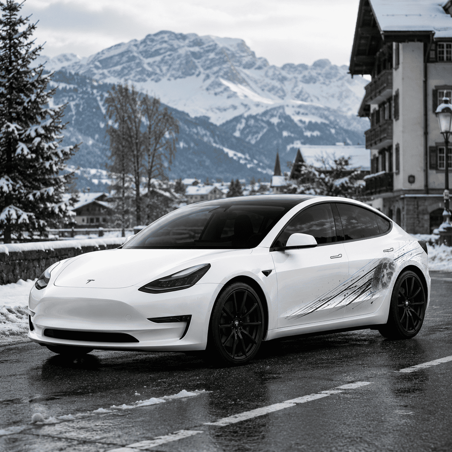 Tesla Model 3 Lunar Impact side decal front three-quarter view in snowy alpine mountain town setting