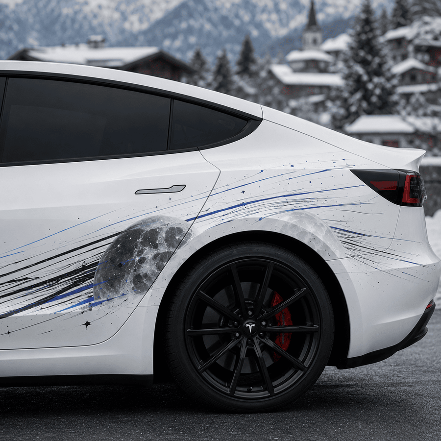 Close-up rear quarter view of Tesla Model 3 Lunar Impact decal showing moon crater and blue streak vinyl detail in snowy alpine village