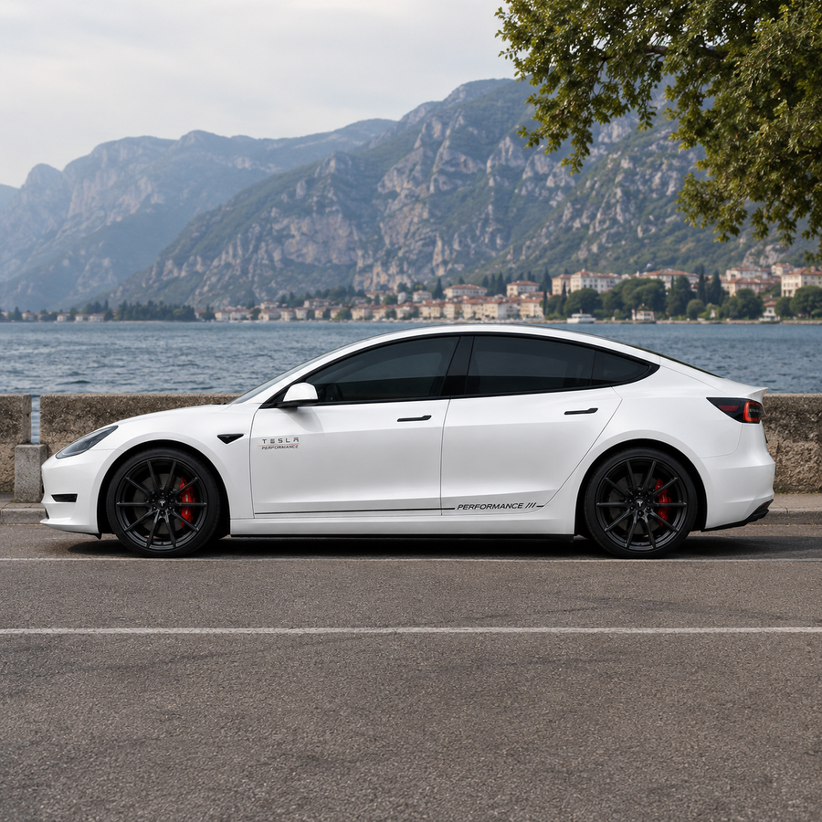 Tesla Model 3 Performance side skirt decal full side view parked by Italian lake with mountain backdrop